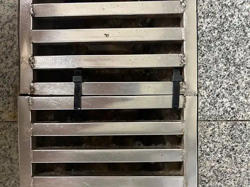 Nylon cable ties fixing drain cover gaps