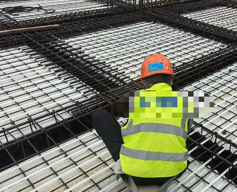Worker using nylon cable ties on a construction site