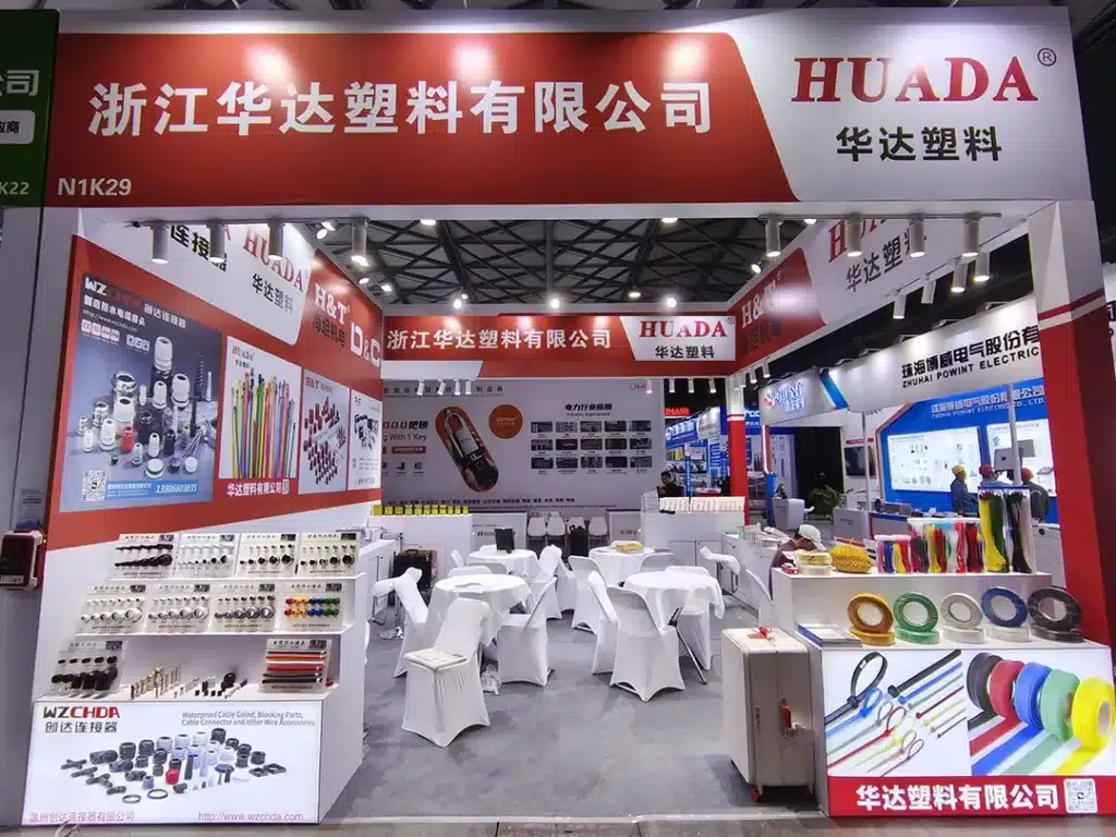 Huada Plastic exhibition booth at EP Shanghai, showcasing nylon cable ties, heat shrink tubing, cable accessories, and wiring management products.