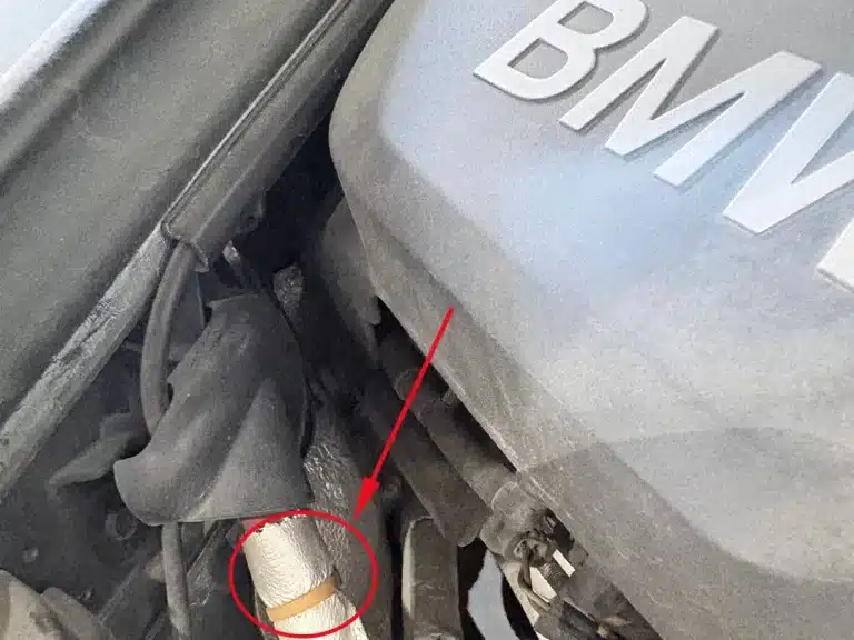 heat resistant cable tie securing an insulated hose in a BMW engine bay
