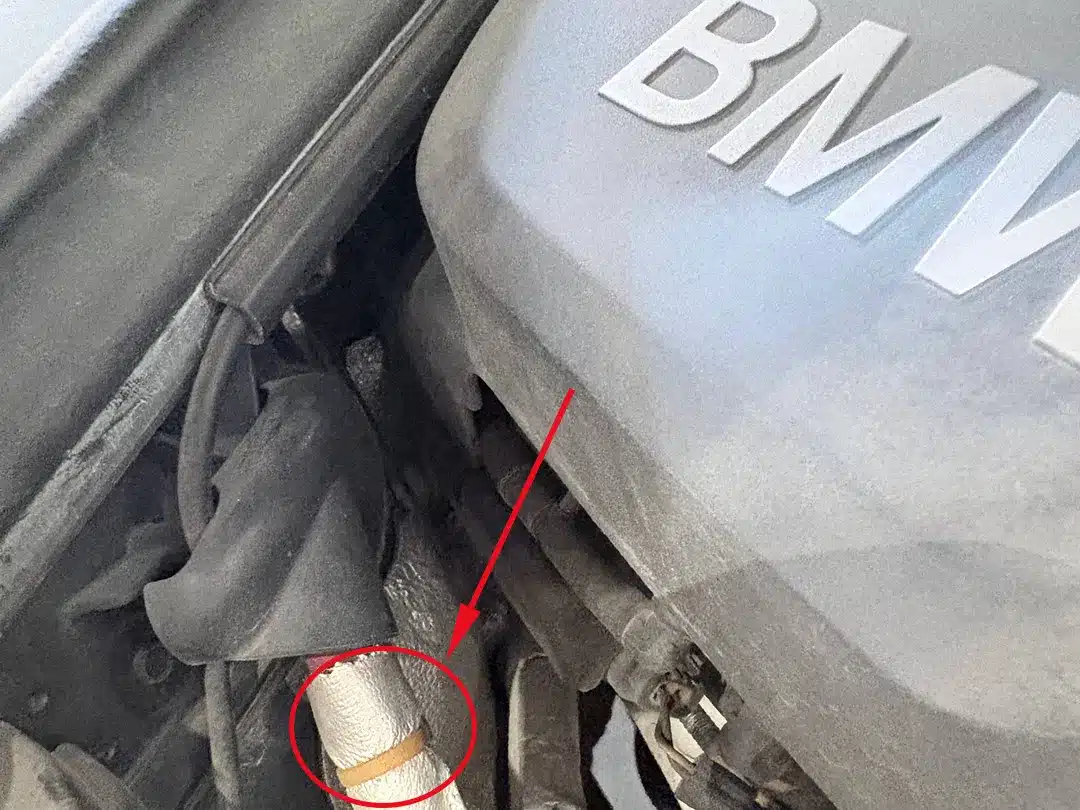 heat resistant cable tie securing an insulated hose in a BMW engine bay