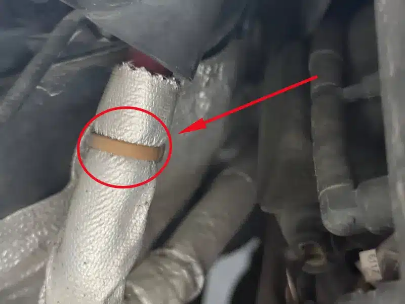 Heat resistant cable tie securing an insulated hose in a BMW engine bay