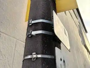 Stainless steel cable ties with Ear-Lokt buckles securing a road sign to a street pole in the UK