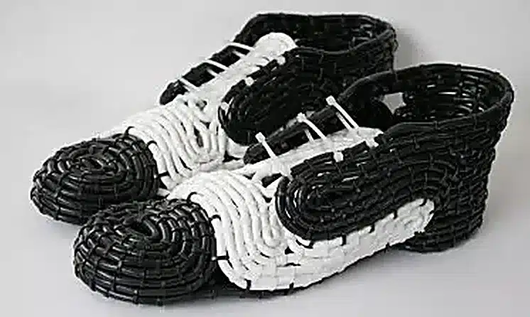 cable ties fastening power cables to form a DIY shoe upper, creating a black-and-white woven sneaker look