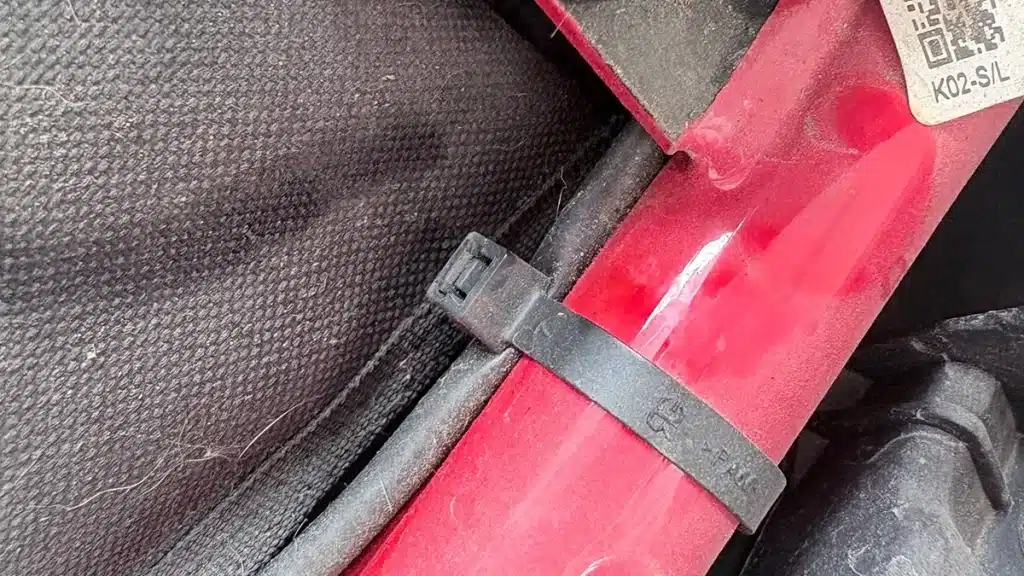 Cable tie securing wiring harness along the frame inside a BMW motorcycle