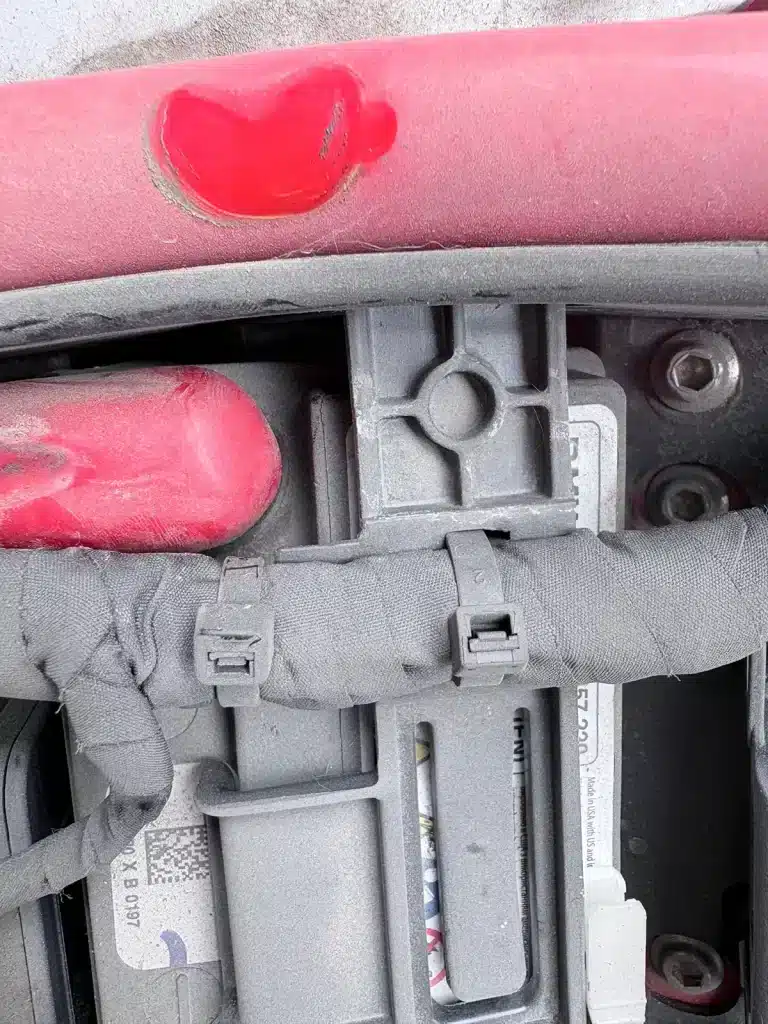 Cable ties fixing wiring harness near control module inside a BMW motorcycle