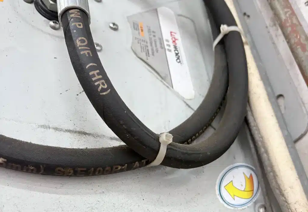 Cable ties securing a hose on workshop equipment