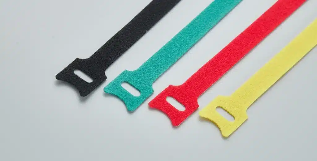 Color hook and loop cable ties in black, green, red, and yellow