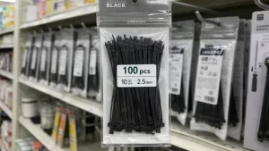 Black nylon cable ties in retail packaging displayed on a supermarket shelf