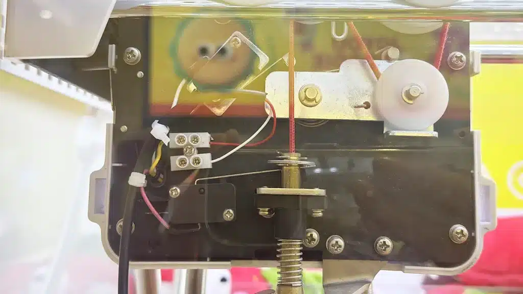 Nylon cable ties organizing internal wires inside a claw machine