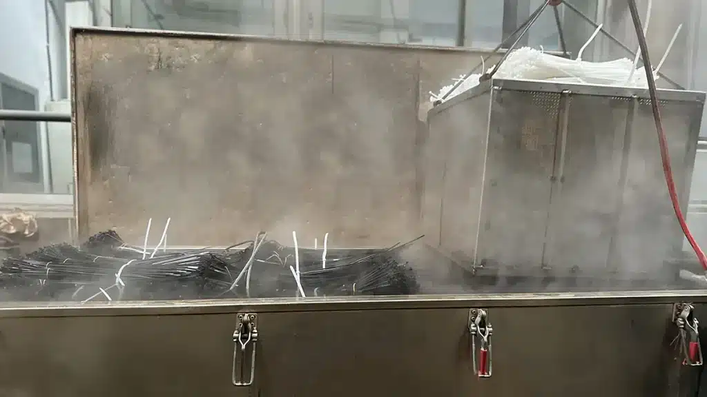PA66 nylon cable ties undergoing warm-water moisture conditioning in a factory tank